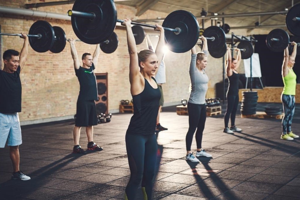 Participants lift barbells