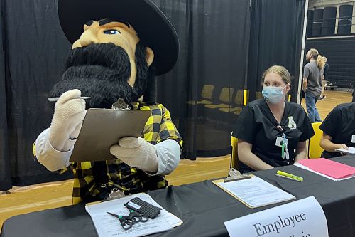 Yosef helps with participant check-in